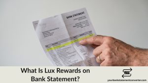 Finger pointing at a Lux Rewards entry on a bank statement