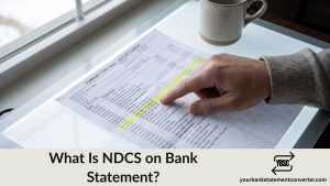 Finger pointing at an NDCS direct debit on a bank statement